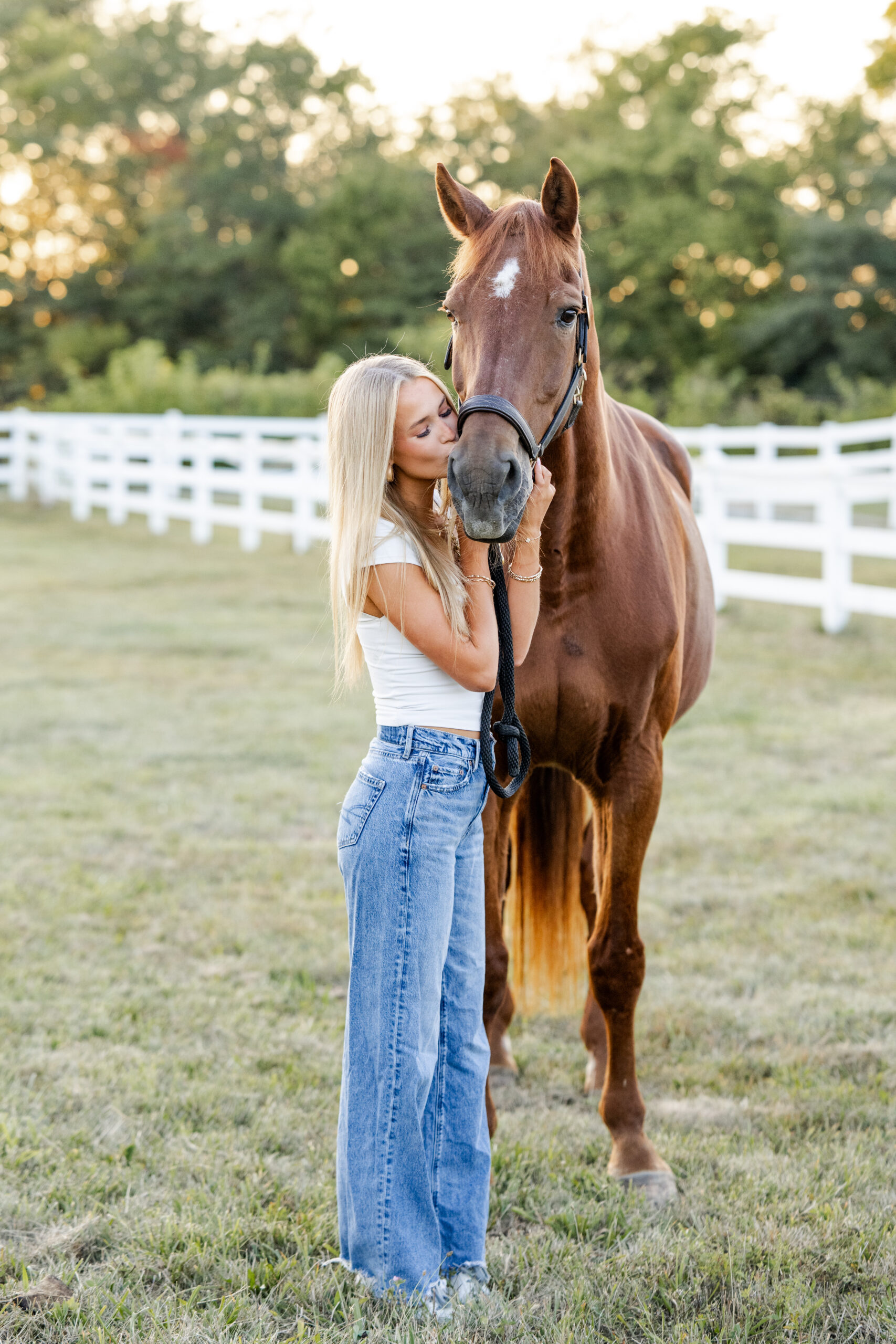 Equestrian kisses her retired horse on the nose during golden hour equestrian photos by Kate Kosnoff Creative.
