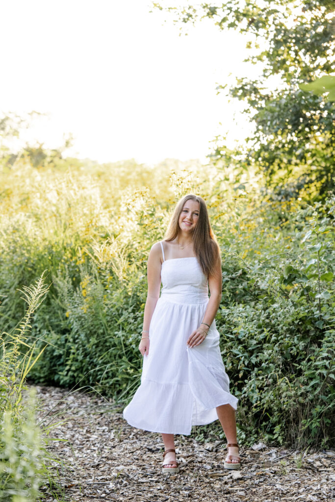 Senior girl twirls her flowy dress during golden hour senior portraits in Indianapolis by Kate Kosnoff Creative